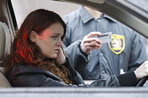 A person inside a car talking to a law enforcer